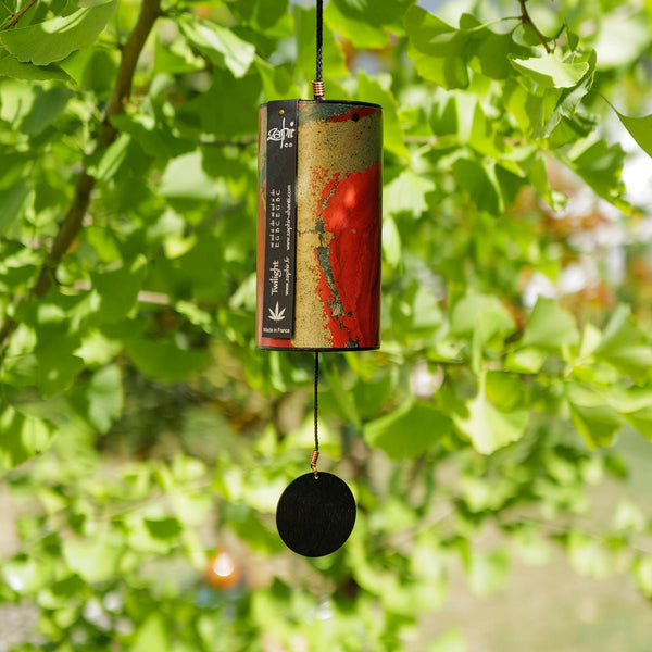 Zaphir Twilight wind chime in red-golden, handcrafted cellulose resonance tube with eight silver-welded metal cords, Autumn season, made in France, Ginkgo Tree in the Background