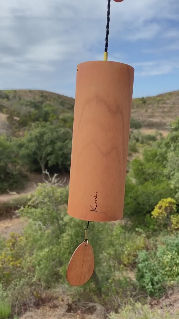 Koshi River chime in cherry wood against green hills, video with the original sound of the Earth Symphony collection